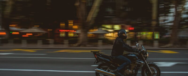 shallow focus photography of riding on cruiser bike while driving at the street